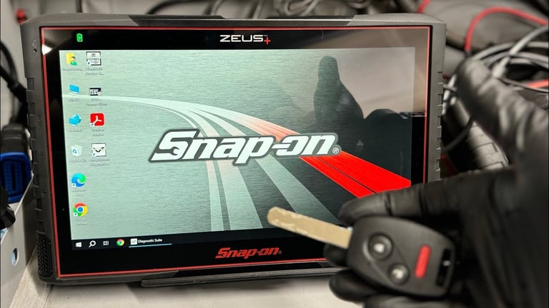 Snap-on diagnostic tablet displaying logo with technician using red tool pointer during automotive service